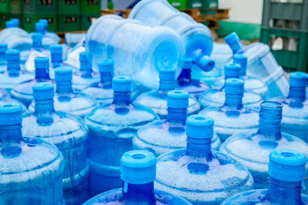 istock Big blue drinking water barrels, bottles, gallon, gets wet in the rain. 954752200