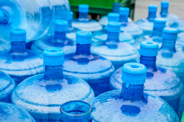 istock Big blue drinking water barrels, bottles, gallon, gets wet in the rain. 954752202