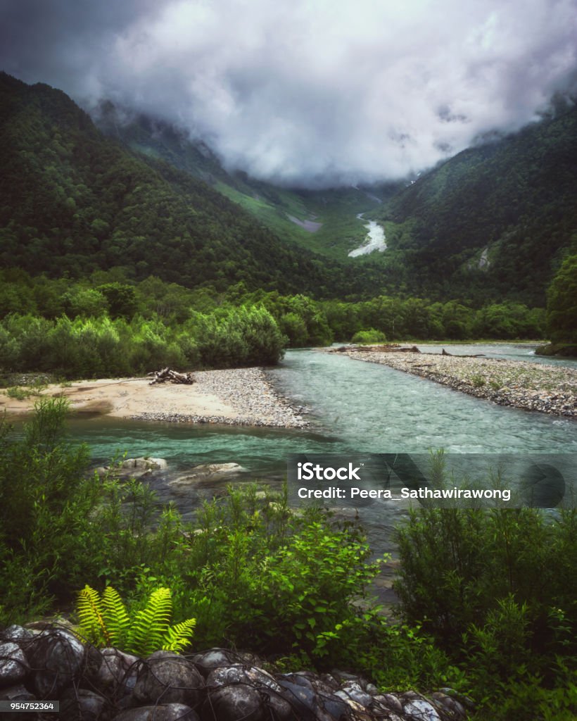 Hotaka mountains and Azusa river in Kamikochi Hotaka mountains and Azusa river with fog in summer, Kamikochi, Nagano, Japan Azusa - California Stock Photo