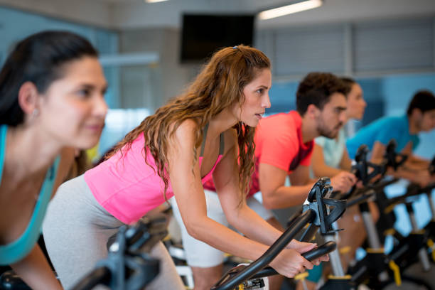 istock Beautiful woman in a exercising class at the gym 954755000