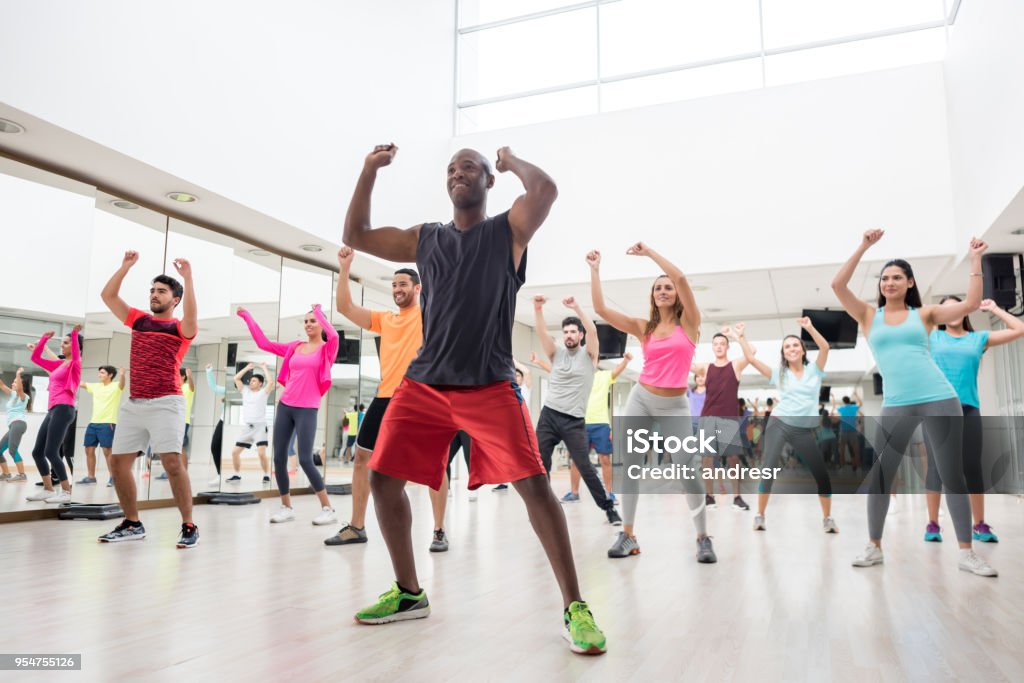 Diverse group of people at a rumba lesson in the gym Diverse group of people at a rumba lesson in the gym all looking very happy and smiling Dancing Stock Photo