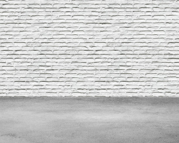 istock Room interior with white brick wall and concrete floor 954755158