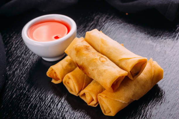 istock lumpias with sweet sauce on a black background 954760556