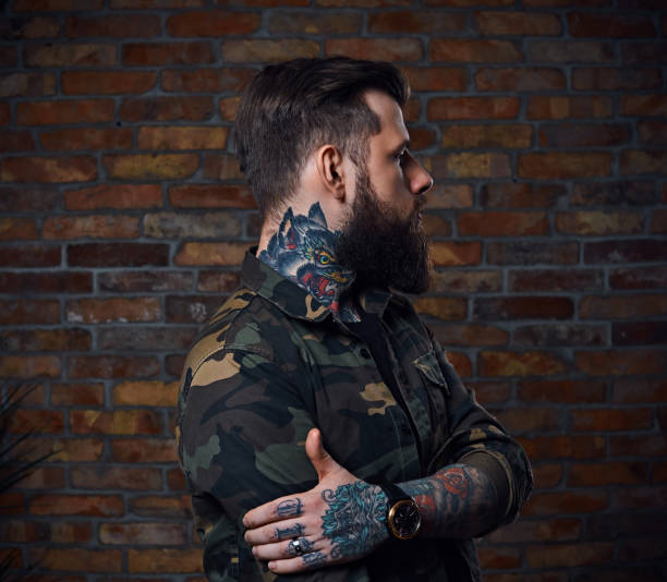 istock Tattooed bearded male in military jacket. 954763122