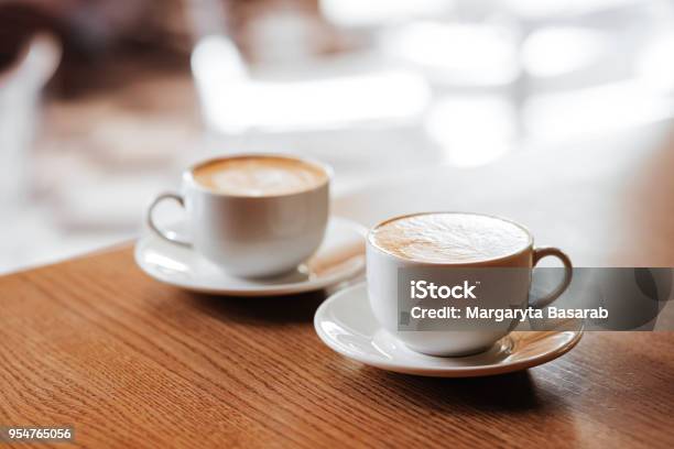 Two Cups Of Cappuccino With Latte Art Stock Photo - Download Image Now - Coffee - Drink, Cafe, Coffee Cup