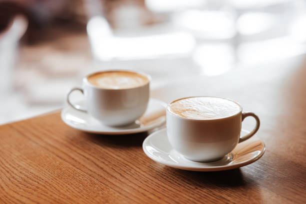 two cups of cappuccino with latte art - espresso table coffee cafe imagens e fotografias de stock