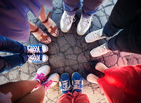 Group of friends with their legs in a complete circle. Friendship concept