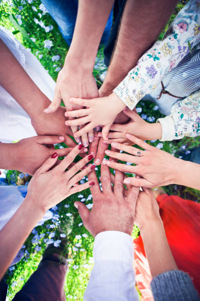 istock Group of friends with their hands in a complete circle 954765282