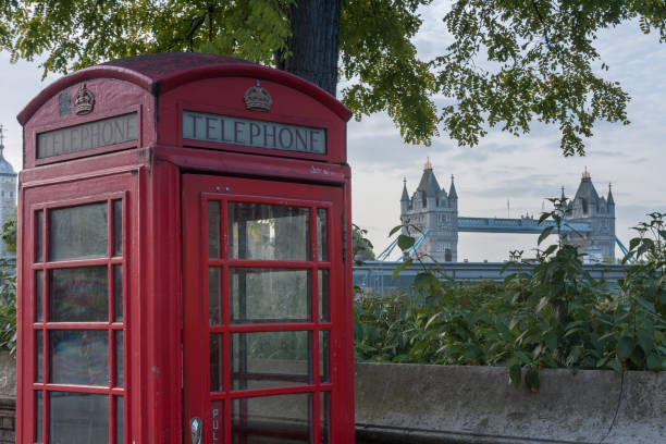 The red telephone box, on background Tower Bridge The red telephone box, on background Tower Bridge, two famous icons of London, England. tower bridge london england bridge europe stock pictures, royalty-free photos & images