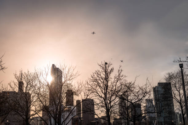 istock Chicago skyline Silhouette with two airplanes flying over the city 954768100