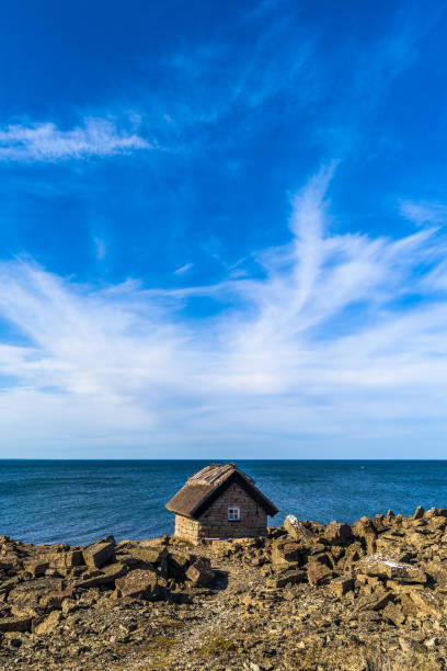 istock Coastal limestone cabin with thatched roof 954769136