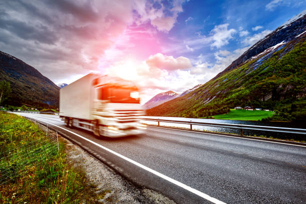 istock Truck and highway at sunset 954769588
