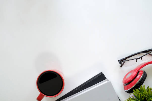 istock Top view table with education desk cup of coffee and book, headphone,glasses with copy space. 954770430