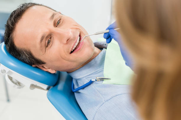 istock Dentist checking patient teeth in modern clinic 954776628