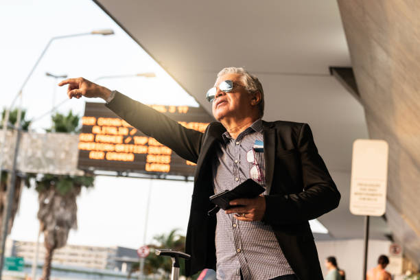 istock Mature Businessman Using Mobile Phone at Airport 954776792