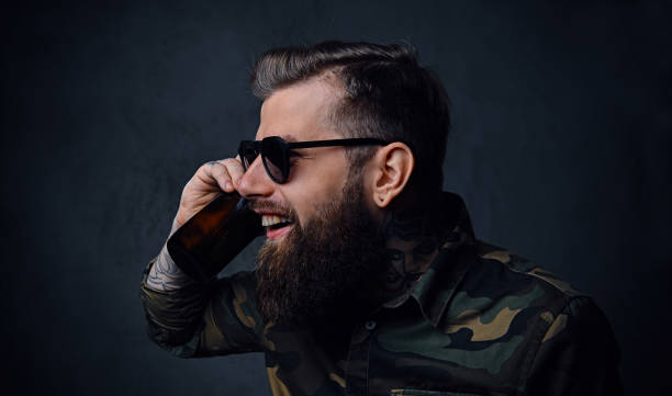 istock A man dressed in military shirt, drinks craft beer. 954779496