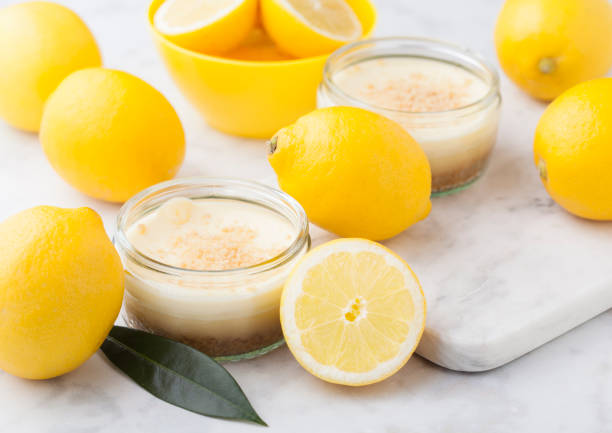 istock Glass jar with lemon cheesecake with fresh lemons 954779770