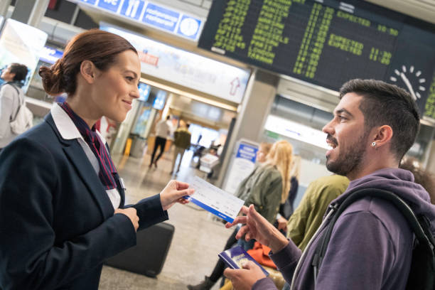 istock Airport attendant helping young hispanic man 954779824