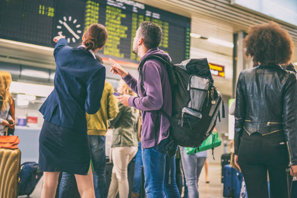 istock Airport employee helping a backpacker 954782408