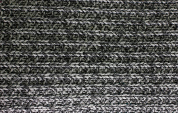 istock Knitted plaid blanket black grey melange texture background 954782772