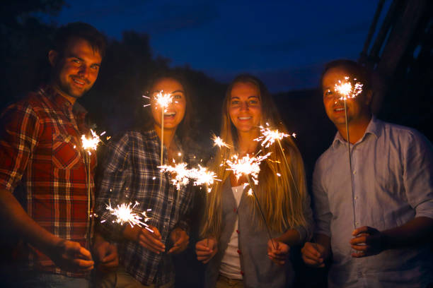 istock Young happpy people with sparklers having fun 954785712