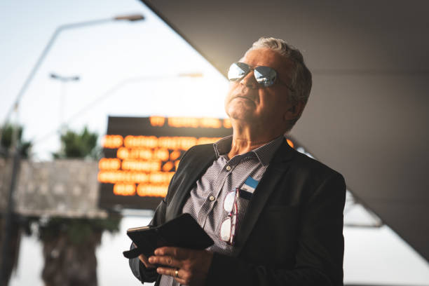 istock Mature Businessman Using Mobile Phone at Airport 954787068