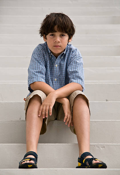 istock Caucasian boy sitting on the staircase 95478795