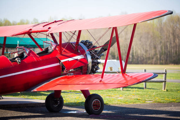 istock Vintage red plane ready to fly on the field 954788362