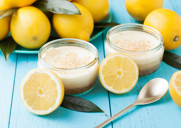istock Glass jar with lemon cheesecake with fresh lemons 954792404