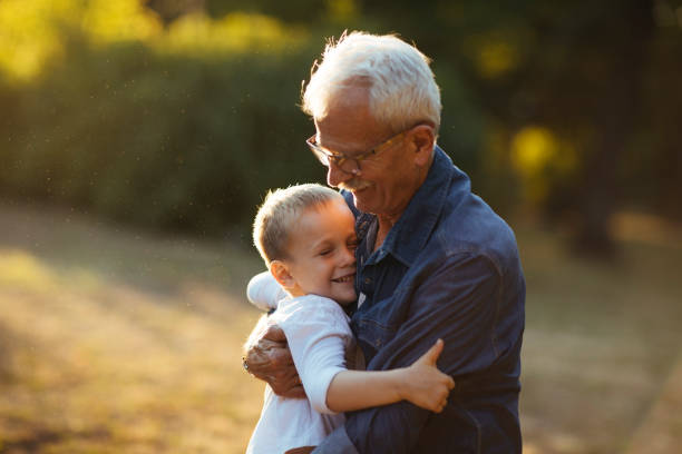 istock Grandchild grandfather hug 954796162
