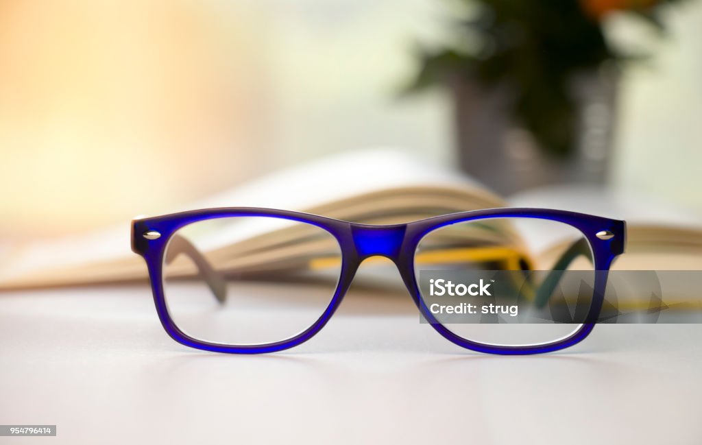 Stylish blue glasses on a blur background. Reading Glasses Stock Photo