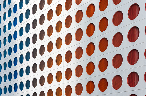 Colorful circles background on white surface wall. Parking lot with circle window at Miami downtown.