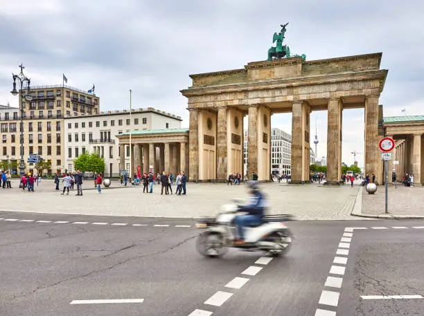 Brandenburg Gate with a motion blur scooter in the foreground