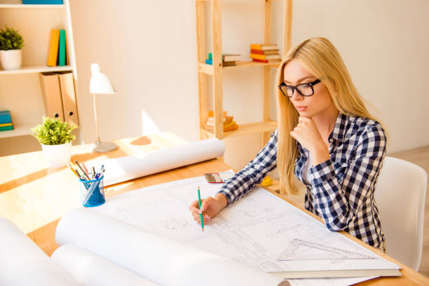 istock Serious girl in glasses working at new difficult project 954812912