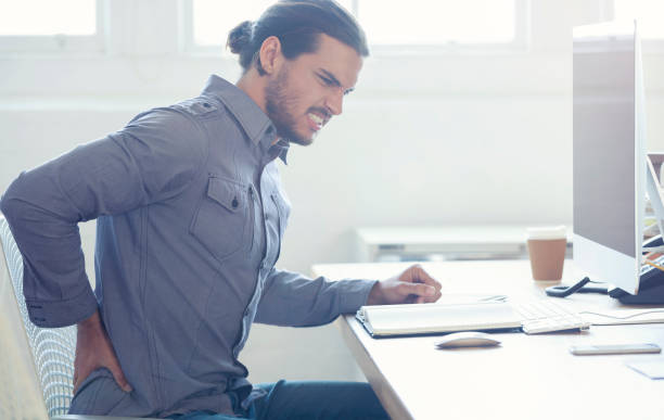 istock Young business man with holding his back in pain. 954813180