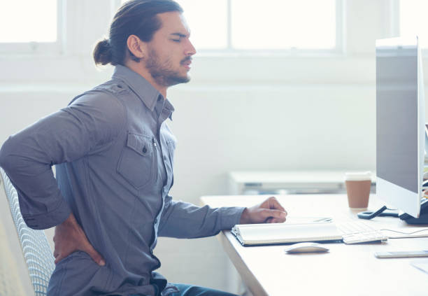 istock Young business man with holding his back in pain. 954813182
