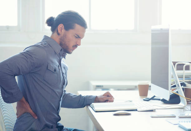 istock Young business man with holding his back in pain. 954813186