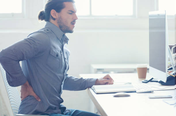 istock Young business man with holding his back in pain. 954813196