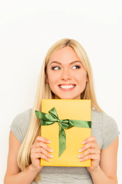 istock Happy smiling young woman holding gift box 954820774