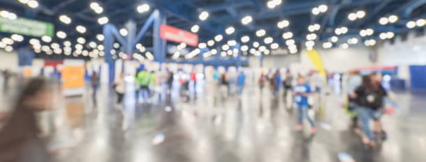 Wide abstract view blurred people at sport event expo Panorama wide view blurred people at sport event in conventional hall, expo fair to pickup running t-shirt. Crowd of people 5K, 10K, half, full marathon race preparation in Houston, Texas, USA tradeshow photos stock pictures, royalty-free photos & images
