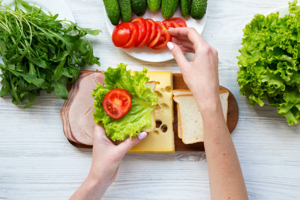 istock Mother preparing food for lunch box, top view 954826178
