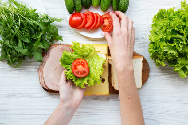 istock Mother preparing food for lunch box, top view 954826182