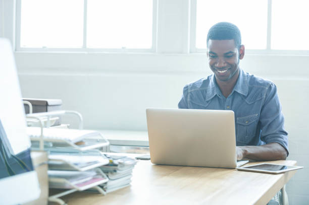 istock African American man working on a laptop computer. 954826426