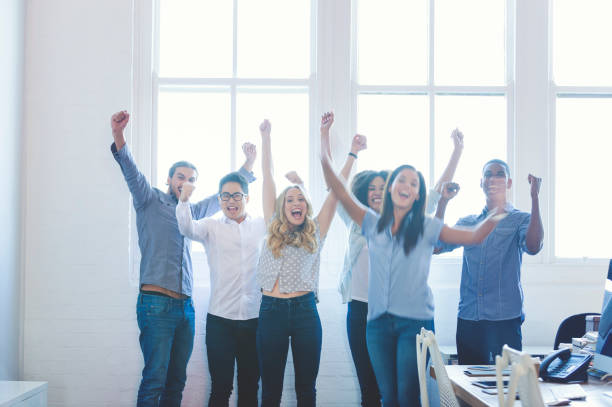 istock Group of young multi cultural business people celebrating. 954826444