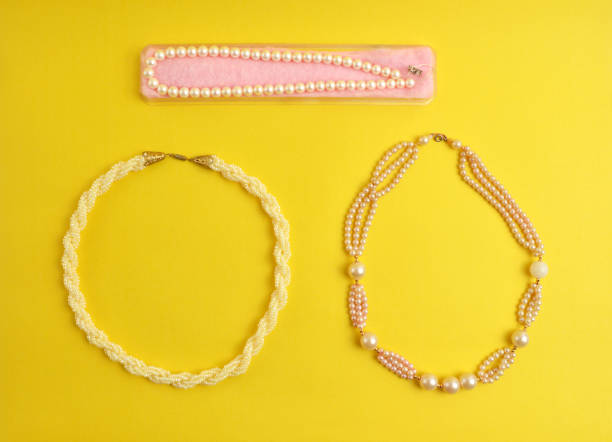 istock Pearl necklaces on yellow 954826872