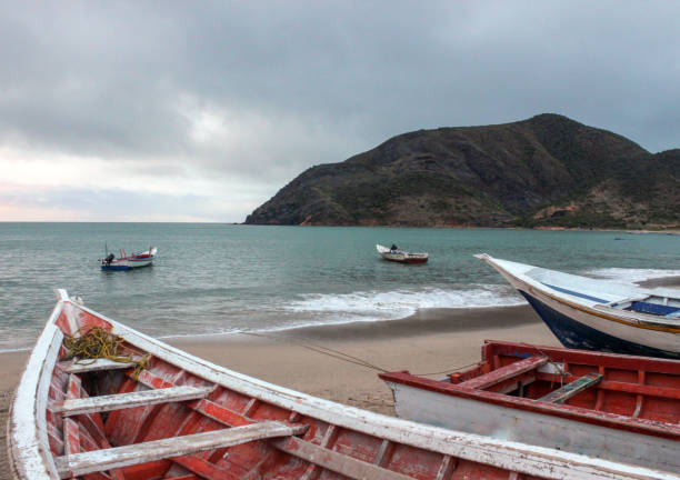 istock Three fishing boats docked on the beach 954827366