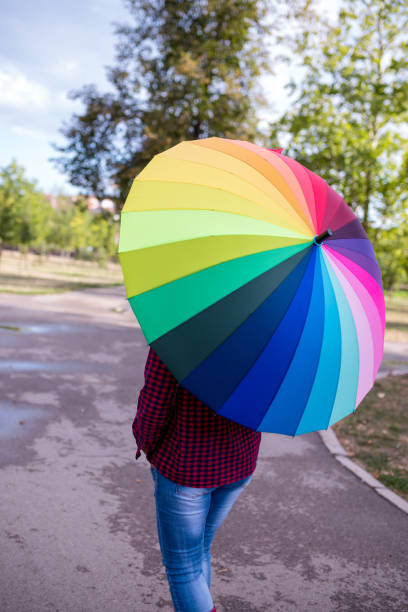 istock Beautiful woman under rainbow umbrella 954833446