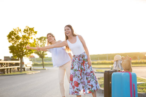 istock Two beautiful young women on the road. 954833726