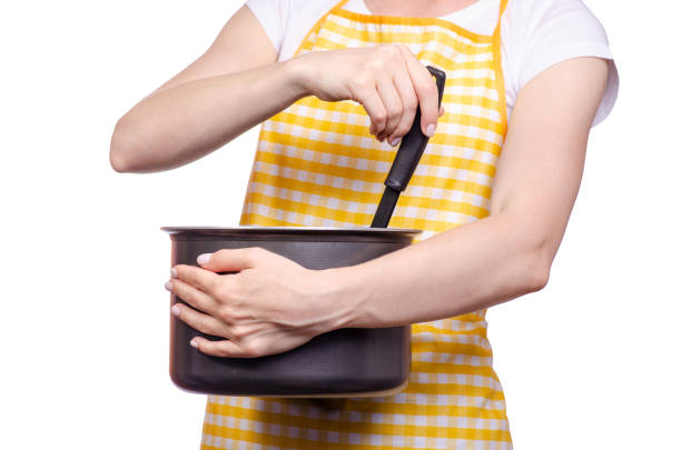 istock Woman with apron in hand kitchen ladle and saucepan 954834278