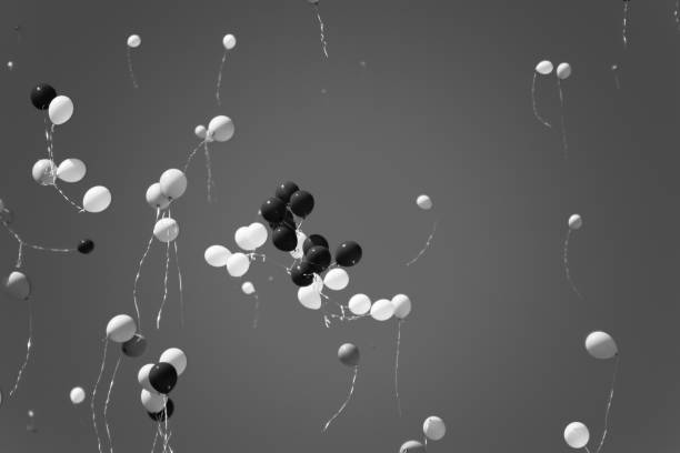 istock Multicolored balls, filled with helium, fly in the blue sky 954834996